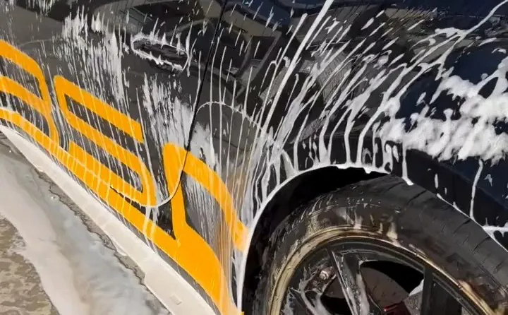Porsche receiving a hand wash for Moto Caribe Detailing
